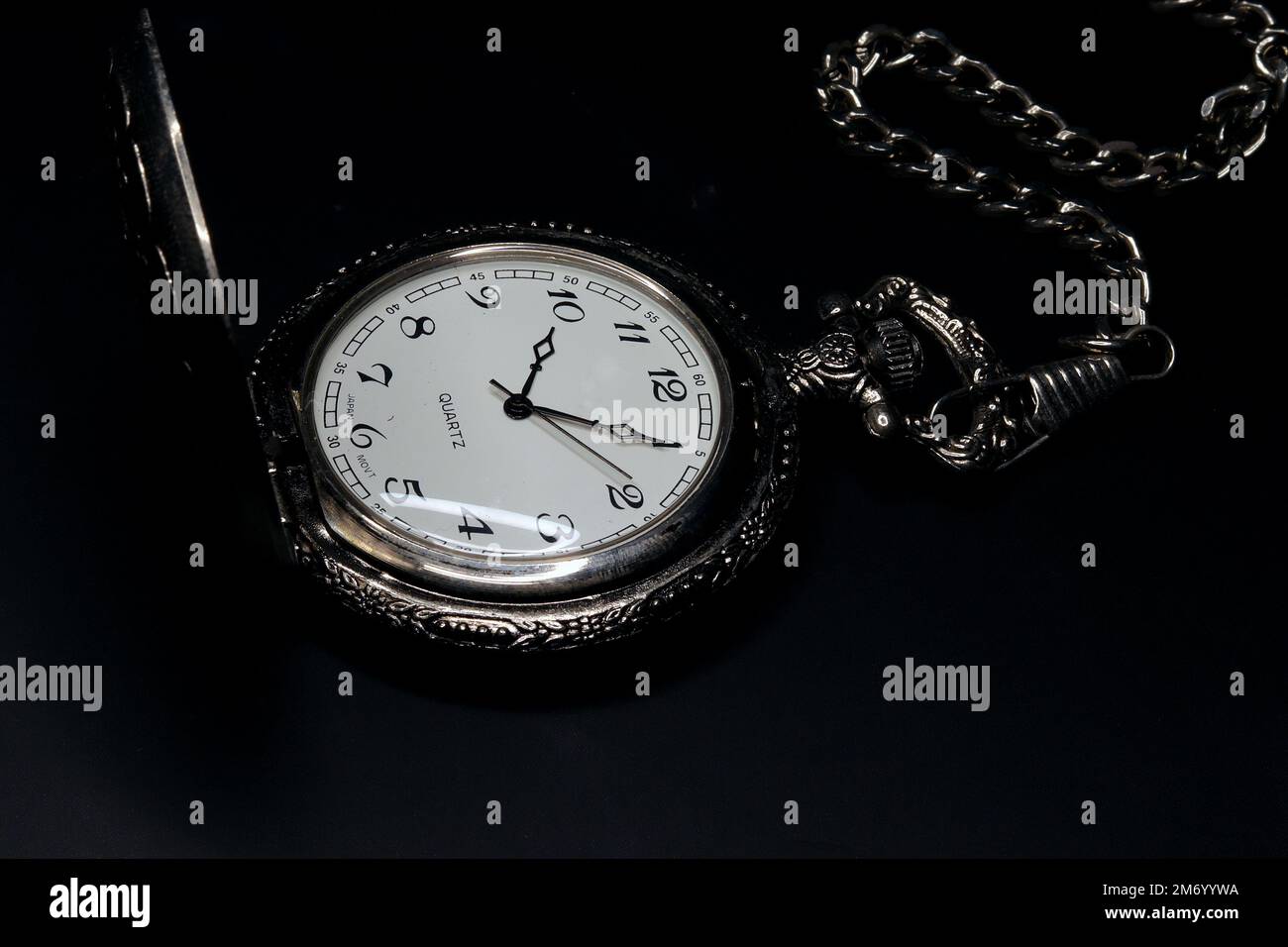 old brass pocket watch on dark background Stock Photo