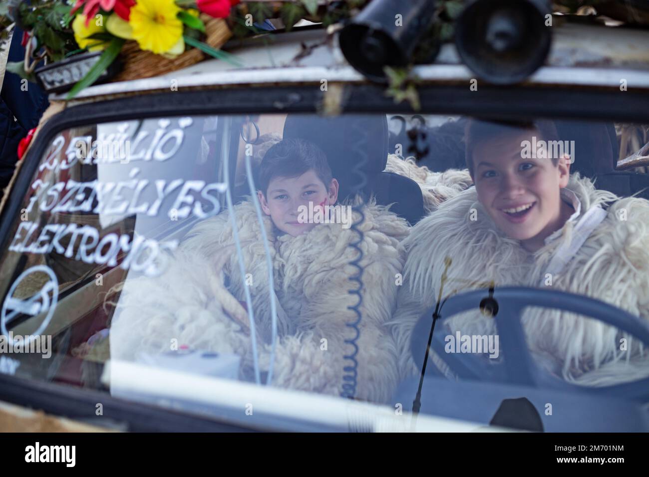 Young boys dressed as buso in a car during the annual Buso festivities / Poklade from Mohacs, Hungary Stock Photo