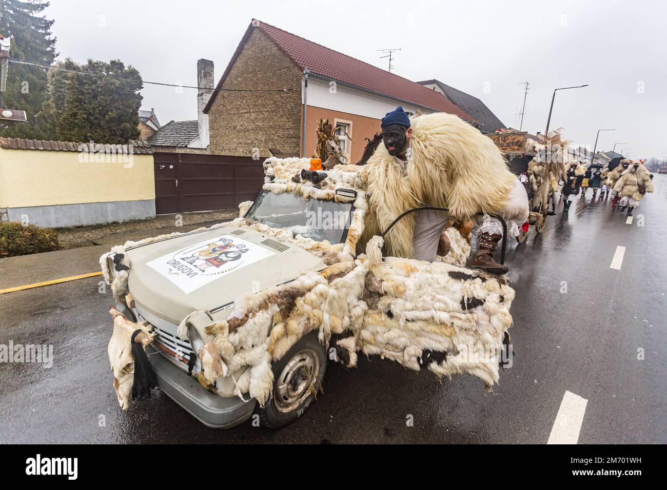 Buso group with a makeshift vehicle dressed up for the annual buso festivities / Poklade in Mohacs, Hungary Stock Photo