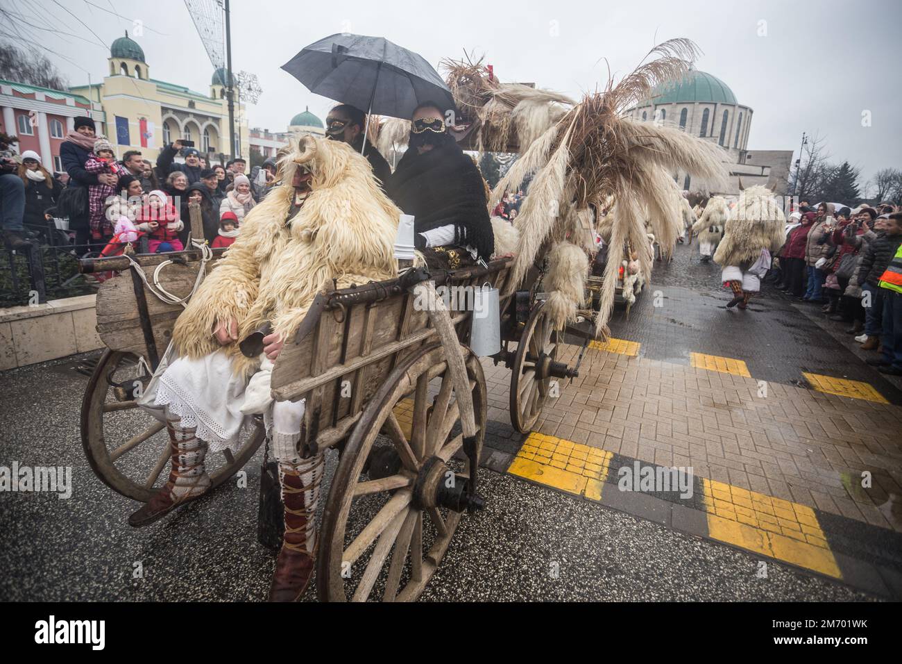 Buso group with a makeshift vehicle dressed up for the annual buso festivities / Poklade in Mohacs, Hungary Stock Photo