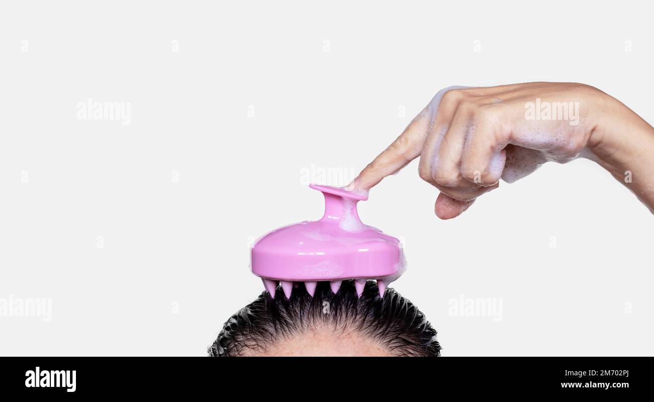 hair growth stimulating,scalp massage.woman use massager shampoo brush