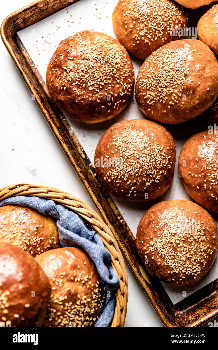 Fresh homemade brioche buns with sesame seed topping Stock Photo