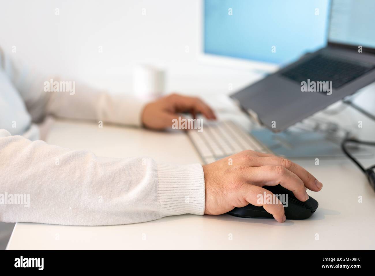 Computer programmer writing program code on computer in office Stock Photo