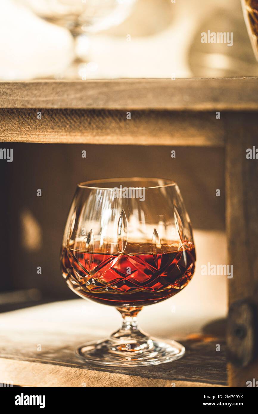 A drink of brandy in a crystal tumbler Stock Photo - Alamy