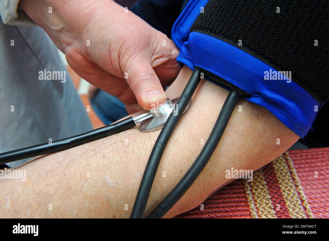 Paramedic hand taking blood pressure and heart rates by tonometer from