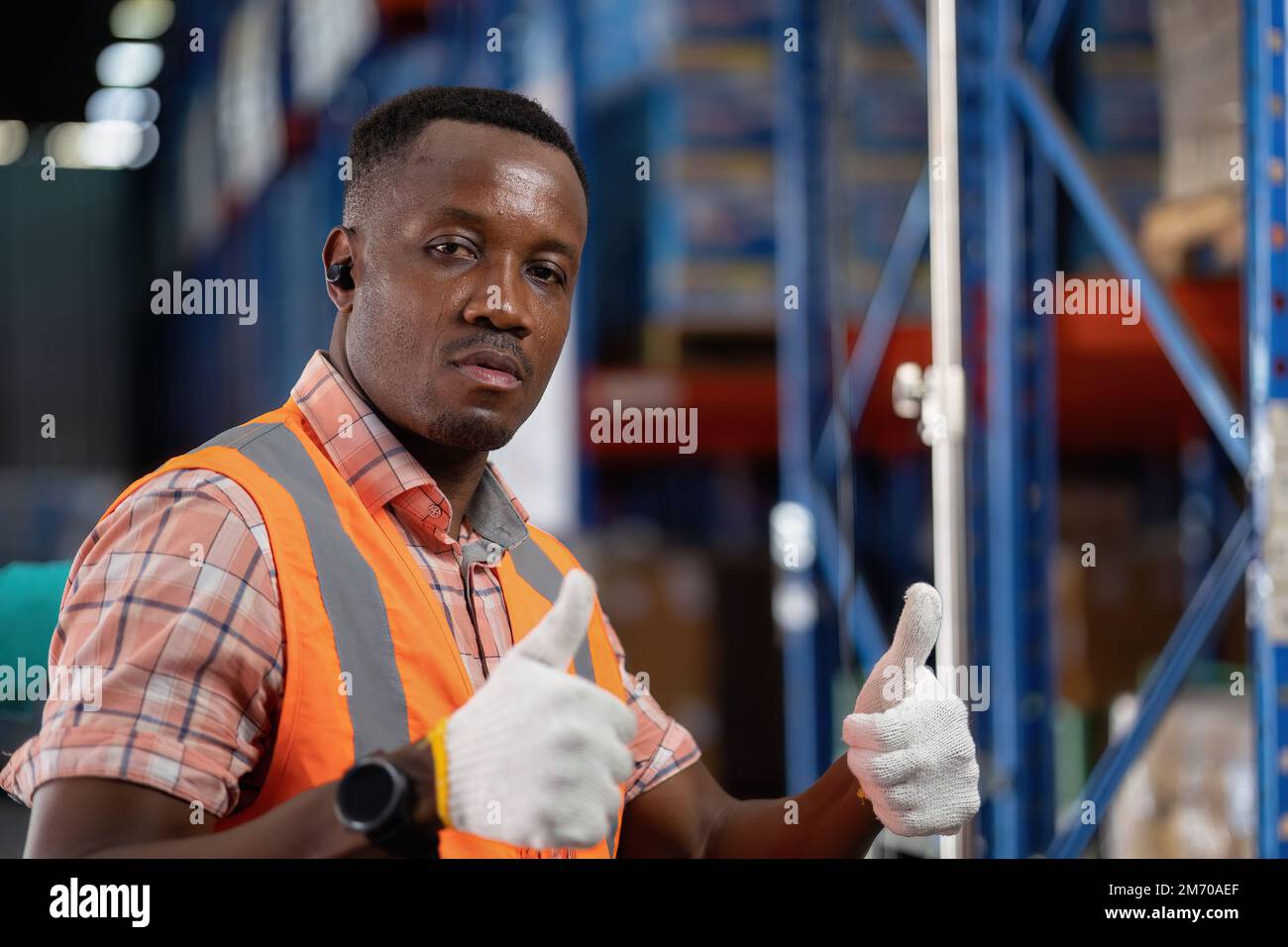 Worker in depot storage warehouse check scan barcode goods box and store on shelf rest portrait Stock Photo