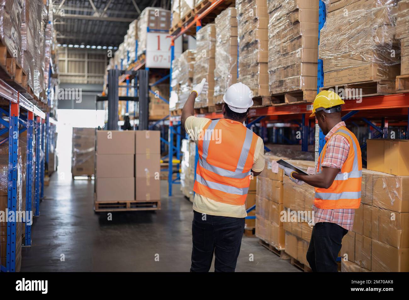 Worker in depot storage warehouse use tablet pc check scan barcode ...