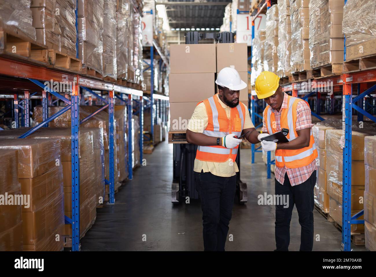 Worker in depot storage warehouse use tablet pc check scan barcode ...