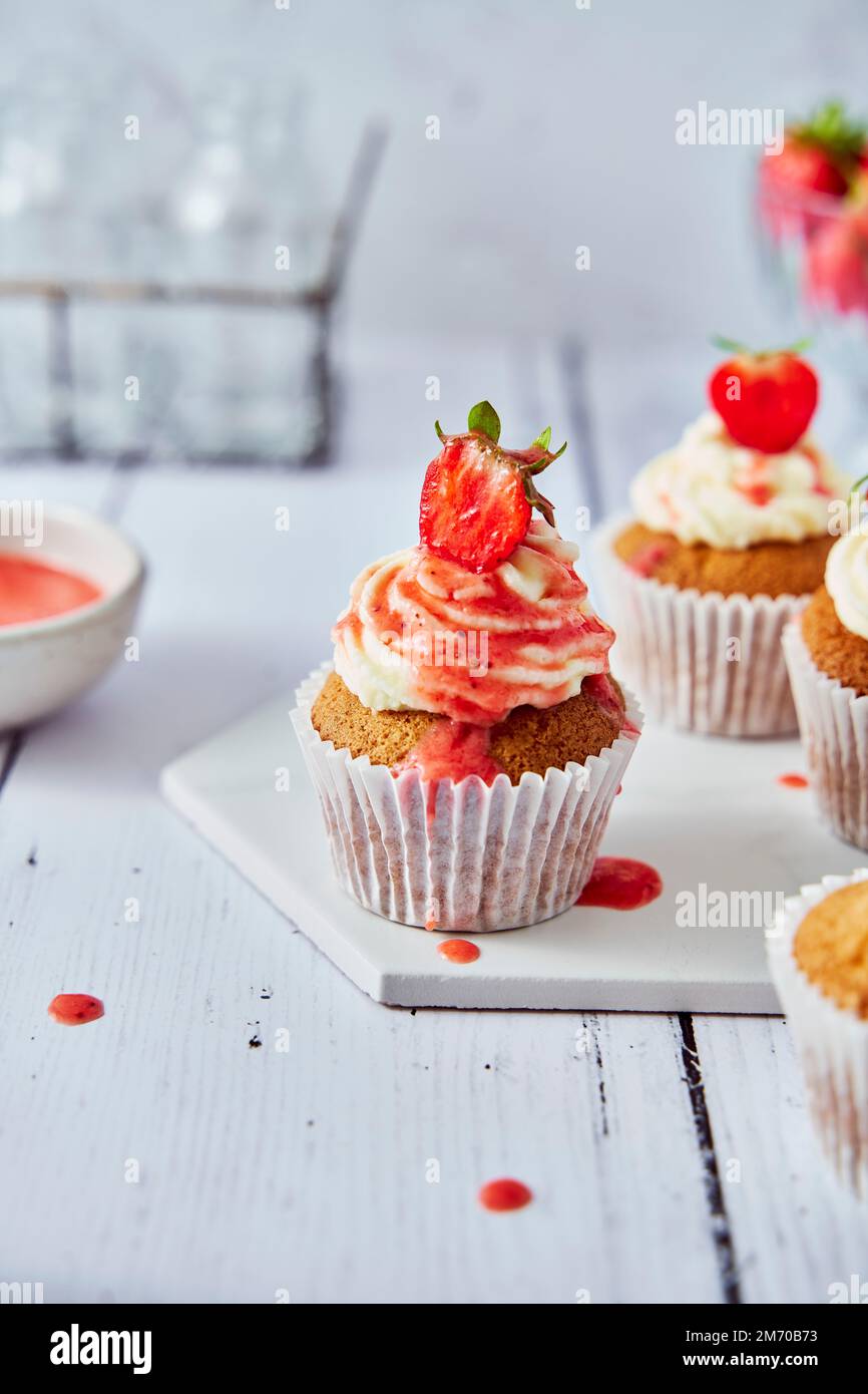 Strawberry Cupcakes with Cream Cheese Frosting and Coulis Stock Photo