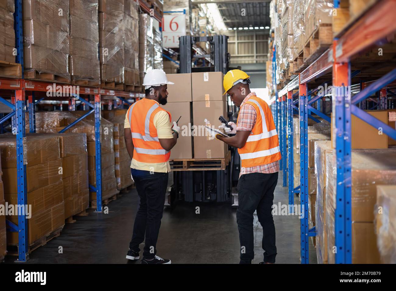 Worker in depot storage warehouse use tablet pc check scan barcode ...