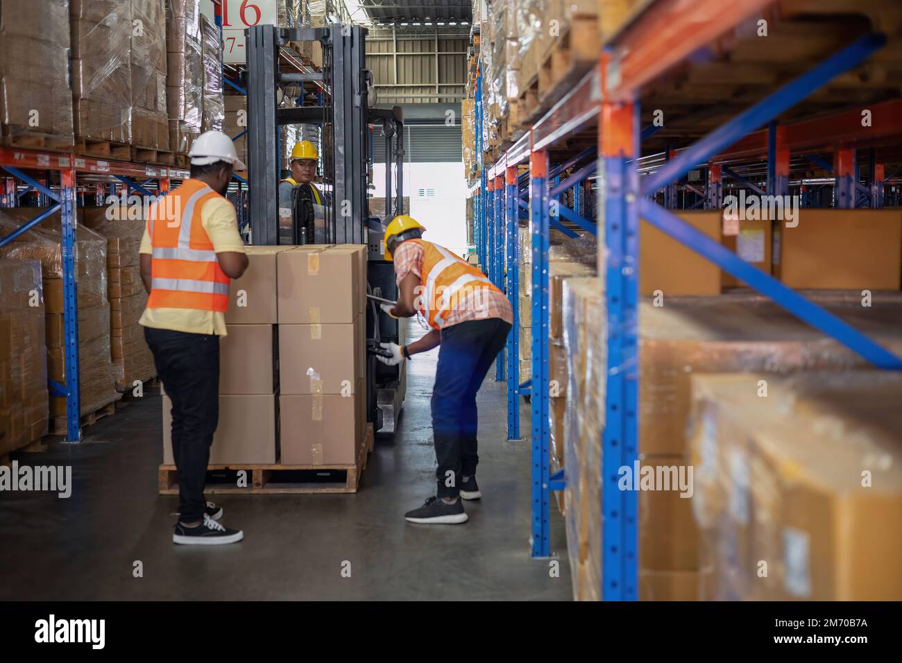 Worker in depot storage warehouse use tablet pc check scan barcode