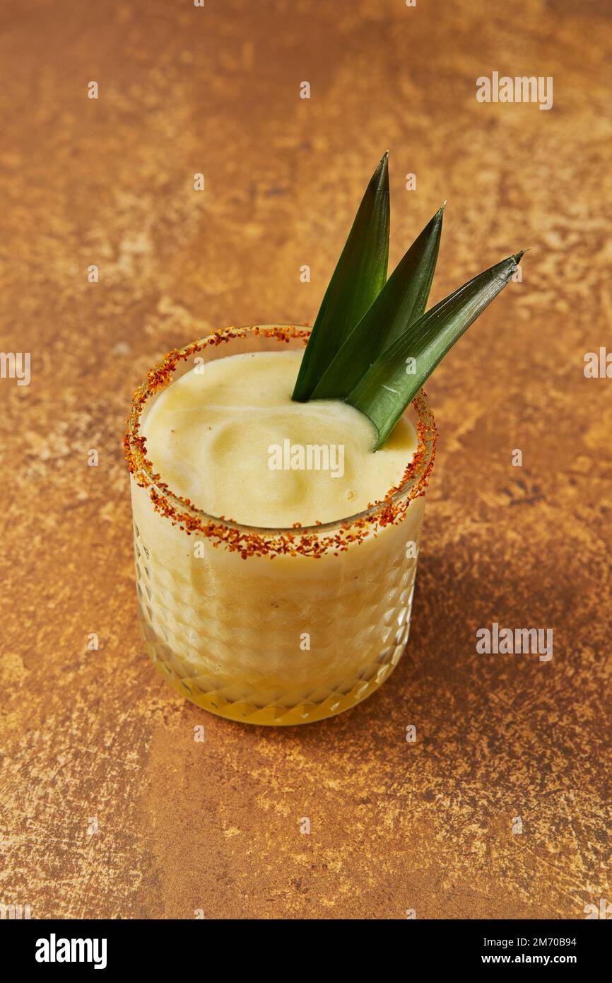 Pineapple Mocktail with Leaf Garnish on Gold Background Stock Photo Alamy