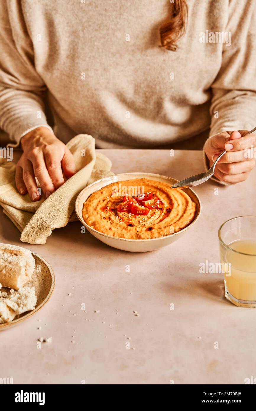 Butternut Squash and Tomato Soup with bread and juice with hands Stock