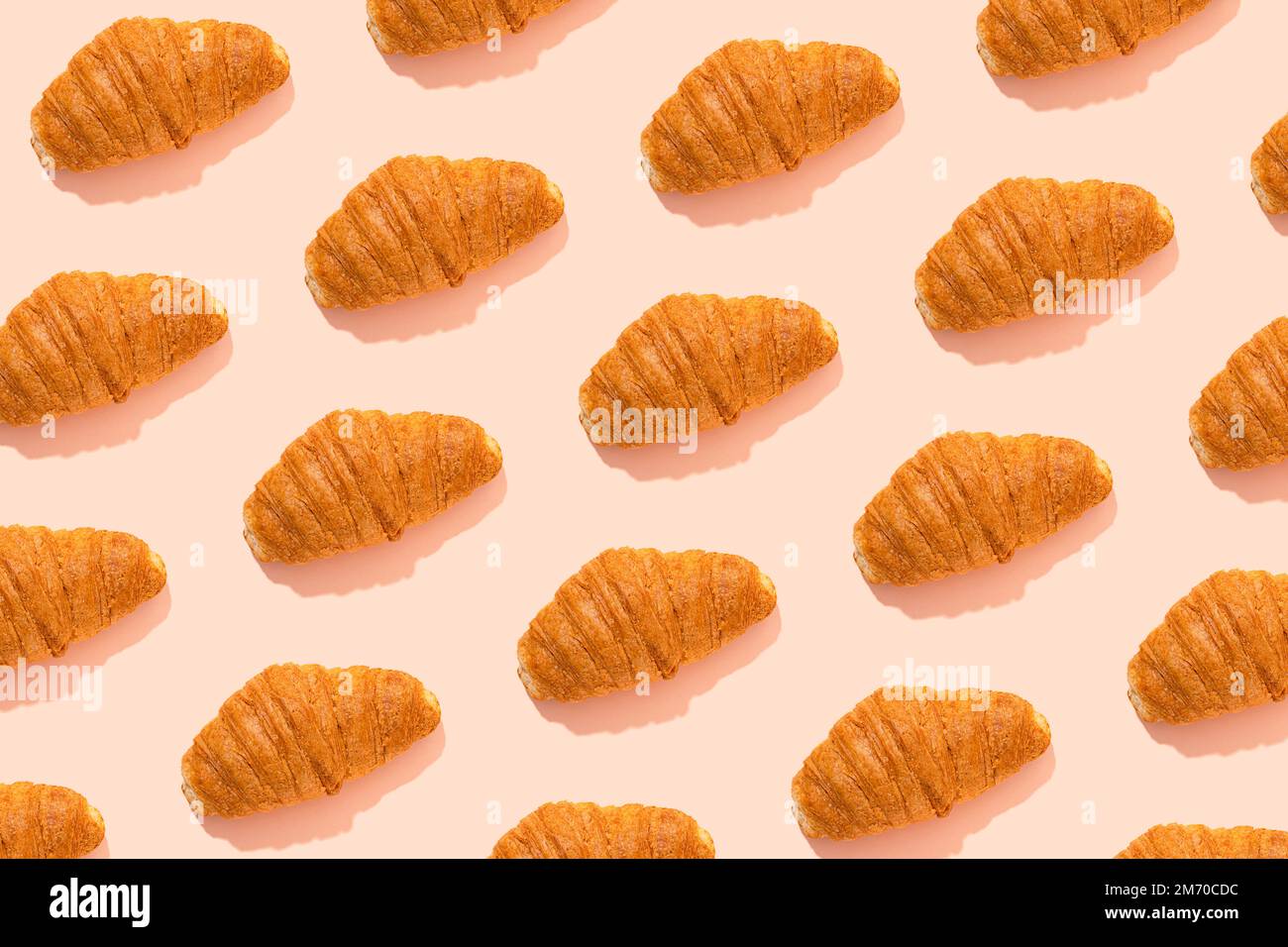 Croissant pattern over pink background Stock Photo