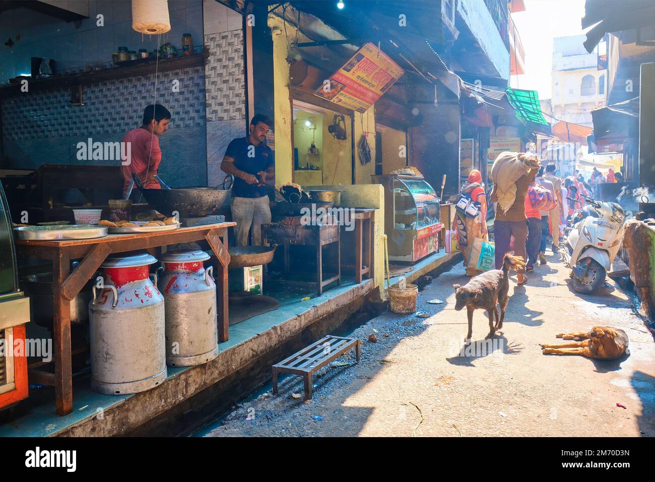 Pushkar, India - November 7, 2019: Indian street with people and food stall with Indian cook makes fresh street food Murukku Stock Photo