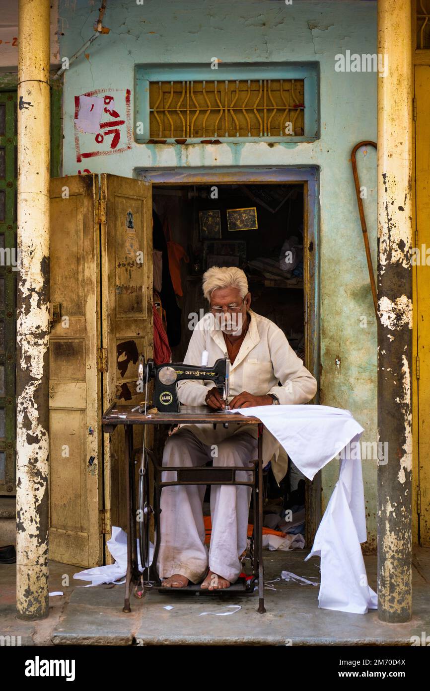 Pushkar, India - November 7, 2019: Indian tailor sewing with old sewing machine in the street of Pushkar, Rajasthan, India Stock Photo