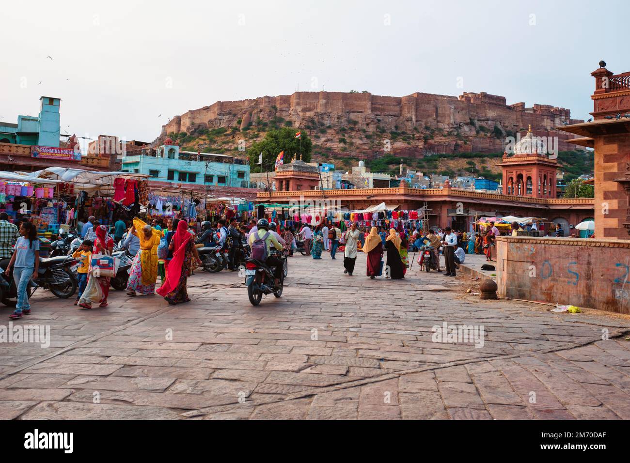 Jodhpur, India - November 14, 2019: People in Sardar Market with Mehrangarh fort in background. Jodhpur, Rajasthan, India Stock Photo