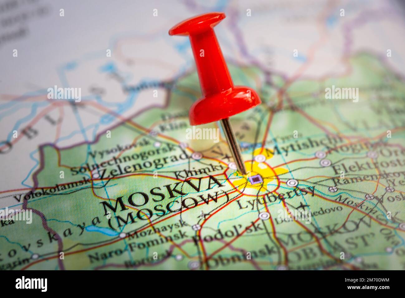 A red pin locating the Russian city of Moscow or Moskva on a detailed map in close up during the Russia invasion of Ukrain Stock Photo