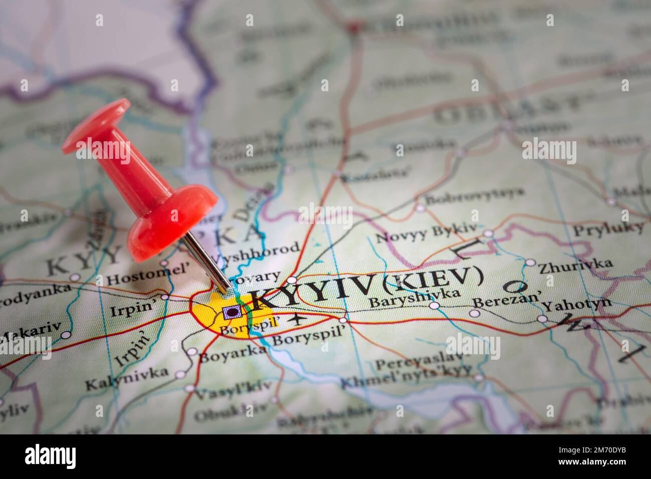 A red push pin marking the location of the Ukraine capital city of Kyiv on a map during the Russian invasion or special military operation Stock Photo