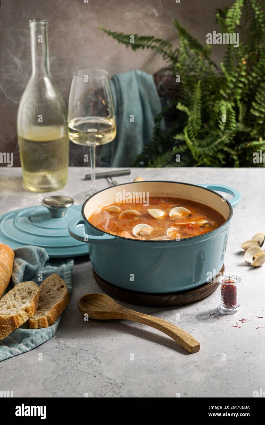 french hot soup Bouillabaisse with clams, fish soup in cast-iron pan Stock Photo
