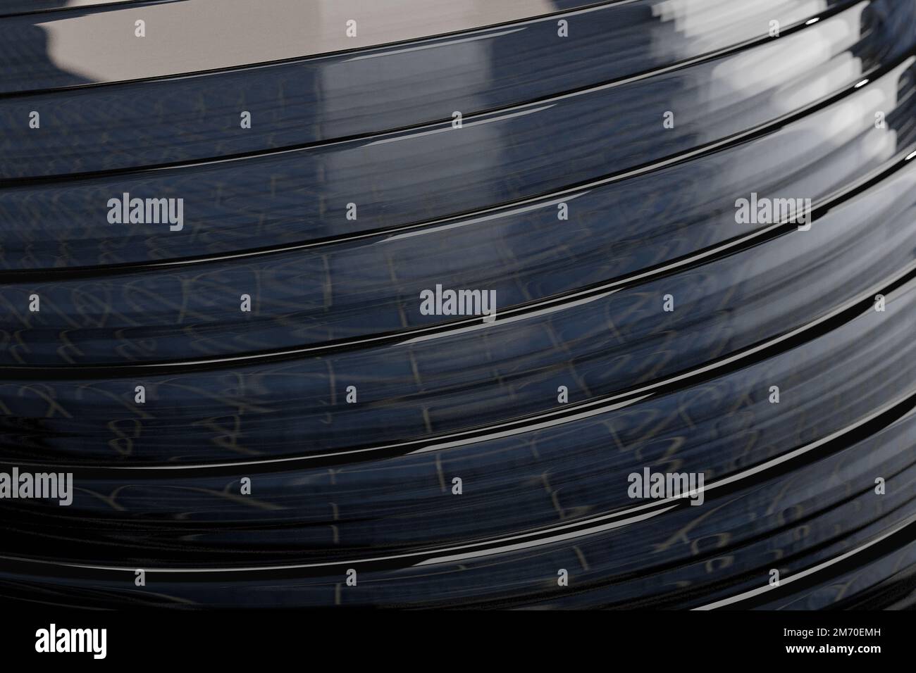 An image of shiny dark grey round objects with layers with a light