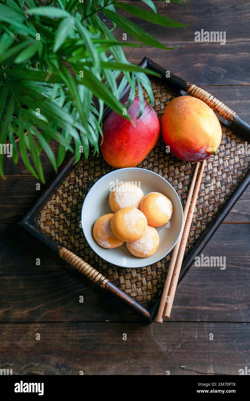 japanese mango mochi cakes with ice cream on a classic wooden asian
