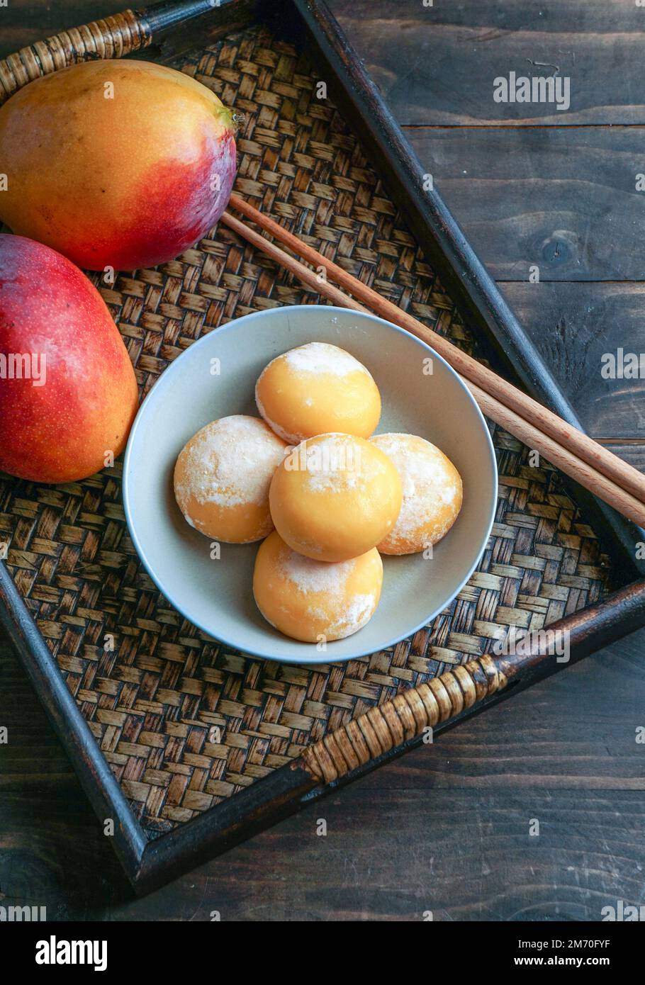 japanese mango mochi cakes with ice cream on a classic wooden asian