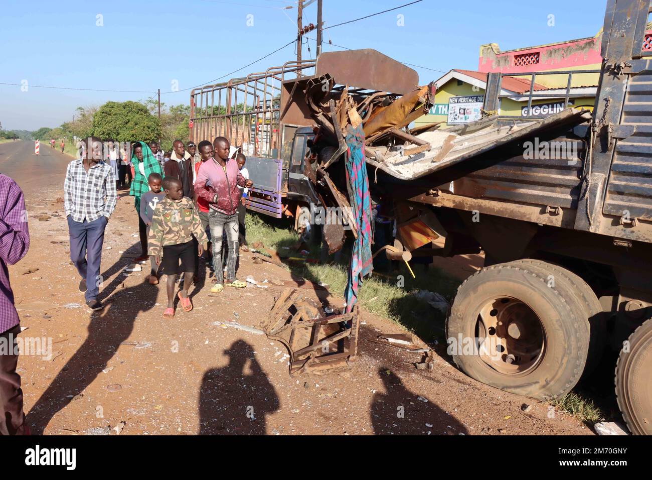 Kampala. 6th Jan, 2023. People look at the wreckage of a bus along the
