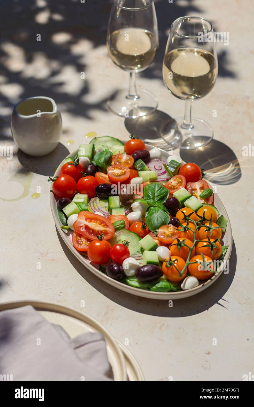 Hard light greek salad with white wine and olive oil Stock Photo