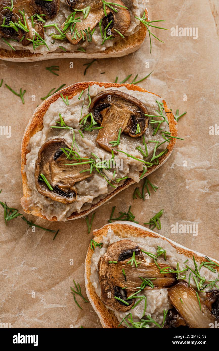 Sandwiches with mushroom pate and mushrooms on kraft paper. Stock Photo