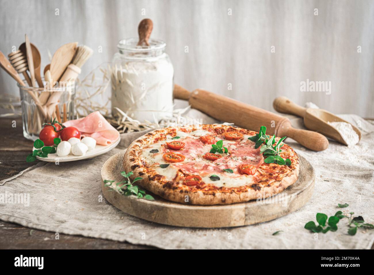 Ham and mozzarella pizza on a cutting board Stock Photo