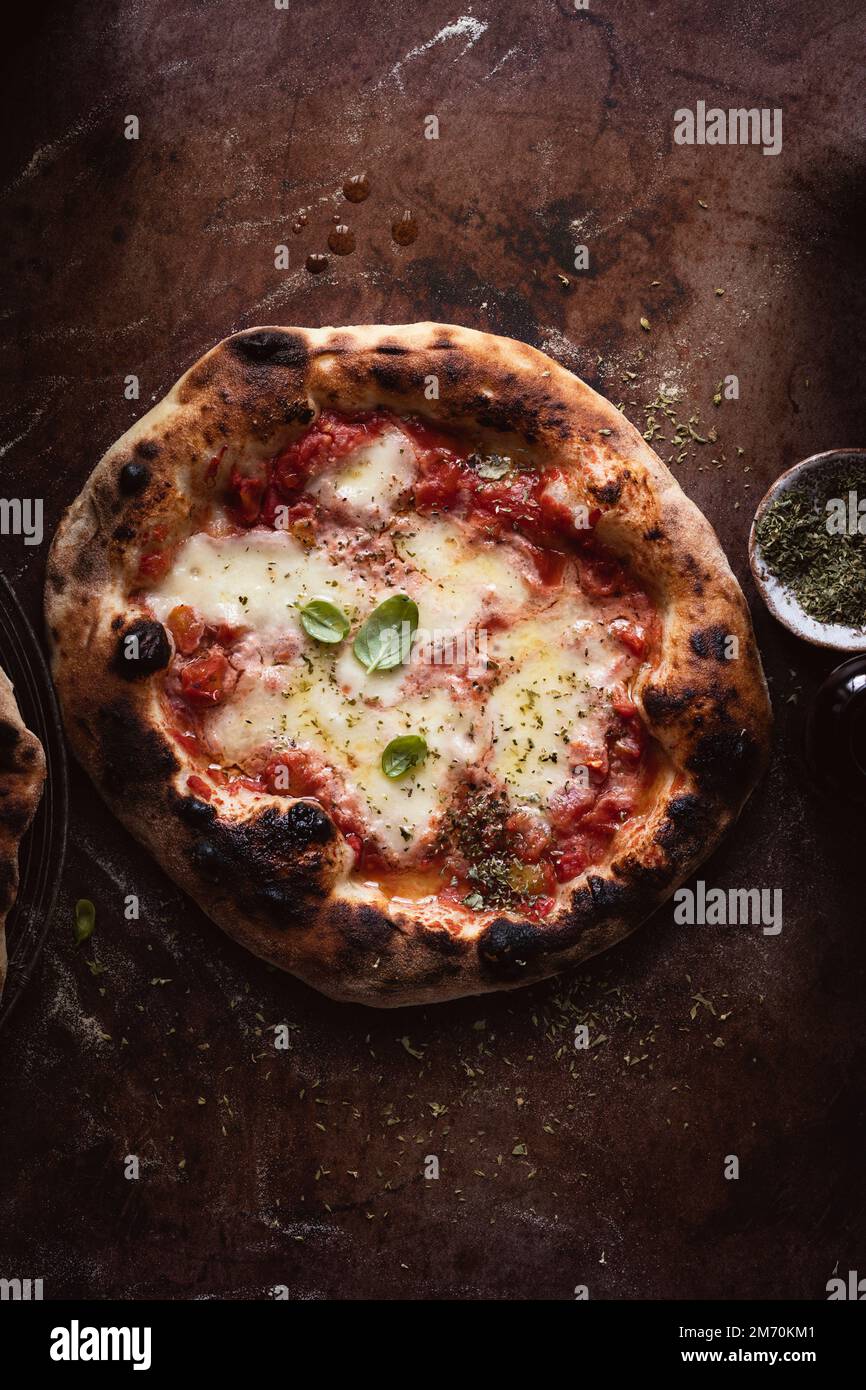 Homemade pizza margherita on a dark surface Stock Photo