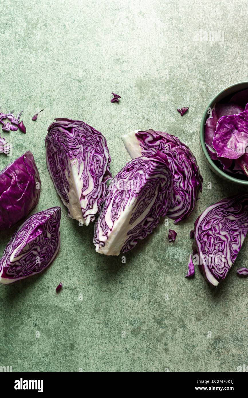 Purple cabbage slices on green background Stock Photo