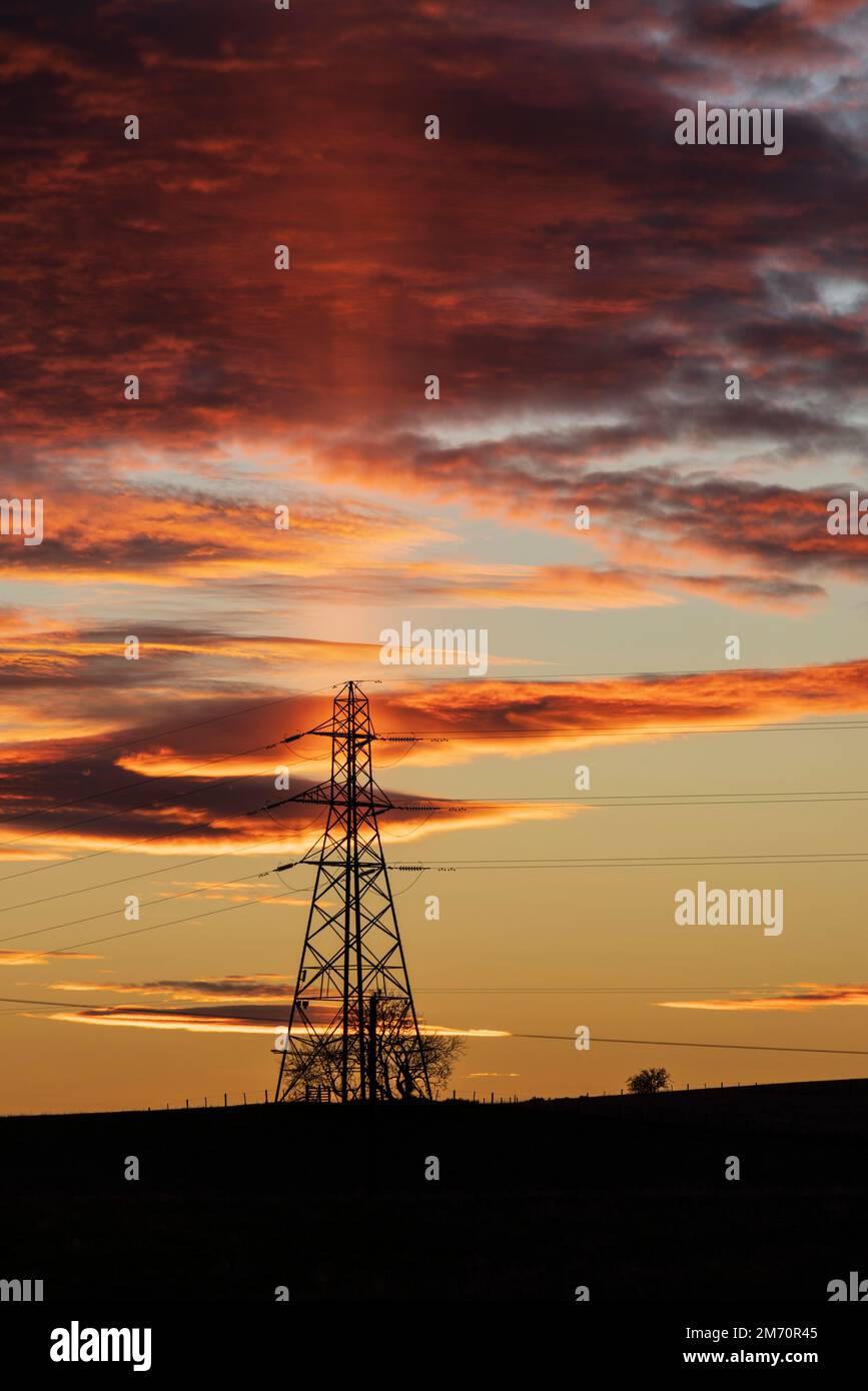 Bowden Loch, near Melrose, Scottish Borders. Sunset behind a pylon