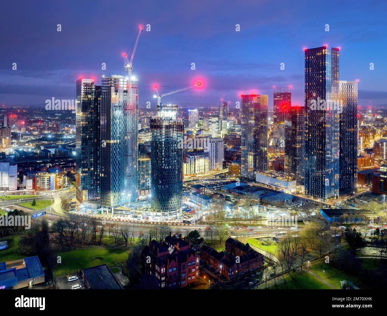 Manchester City centre Aerial night view of Deansgate Square Manchester England, construction building work at dawn with city lights and dark skies Stock Photo