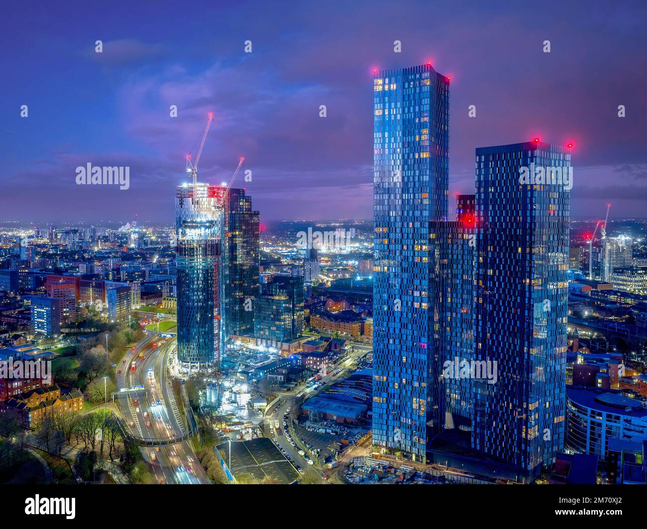 Manchester City centre Aerial night view of Deansgate Square Manchester England, construction building work at dawn with city lights and dark skies Stock Photo