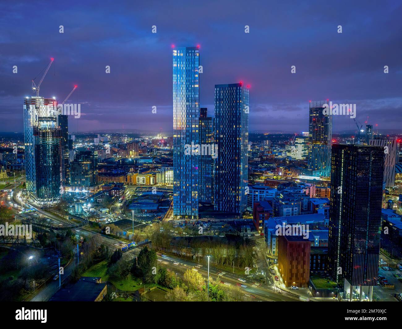 Manchester City centre Aerial night view of Deansgate Square Manchester England, construction building work at dawn with city lights and dark skies Stock Photo