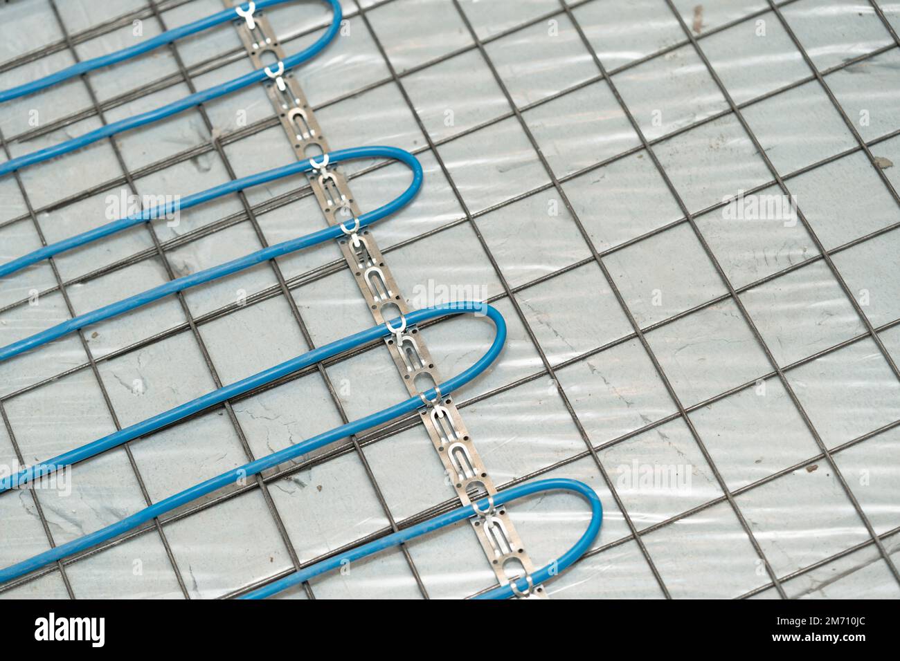 Installation of underfloor heating under the cementsand screed Stock