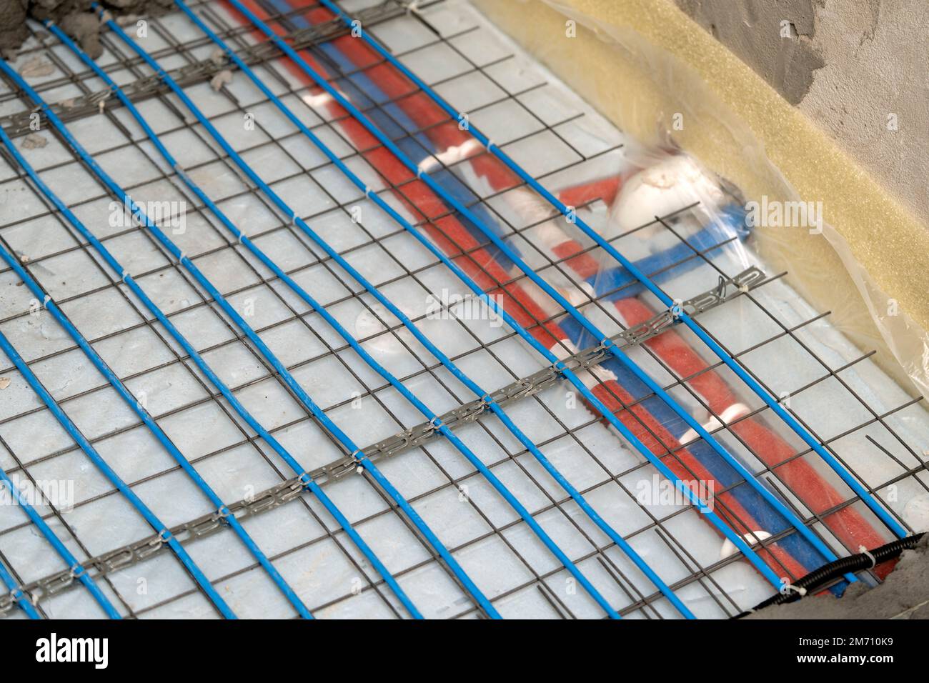 Installation of underfloor heating under the cementsand screed Stock
