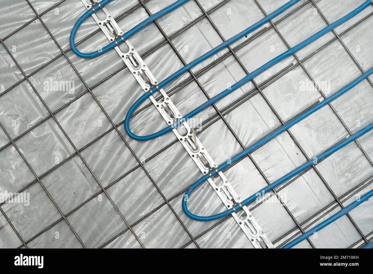 Installation of underfloor heating under the cementsand screed Stock