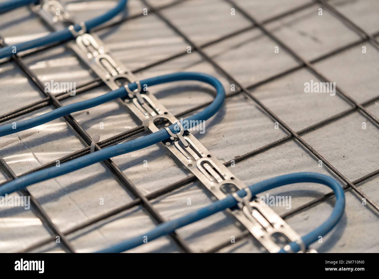 Installation of underfloor heating under the cementsand screed Stock