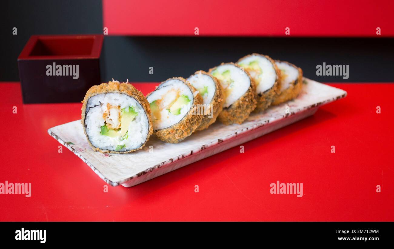 Chicken hot roll. Sushi roll stuffed with chicken and fried whole with breadcrumbs. Stock Photo