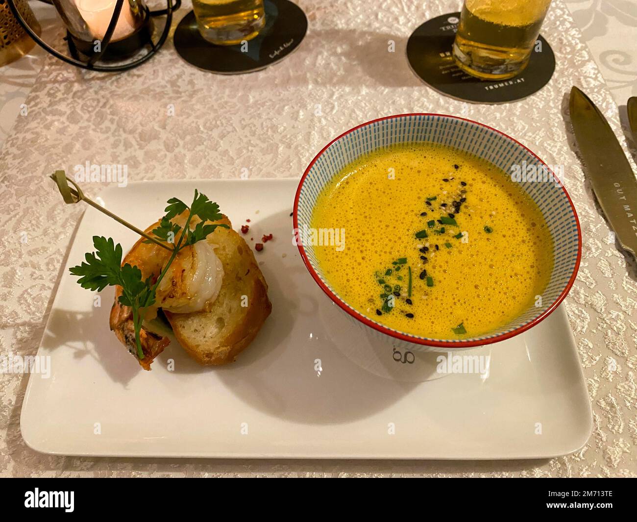 Appetizer, pumpkin cream soup with shrimp on a finely decorated table, Hesse, Germany Stock Photo