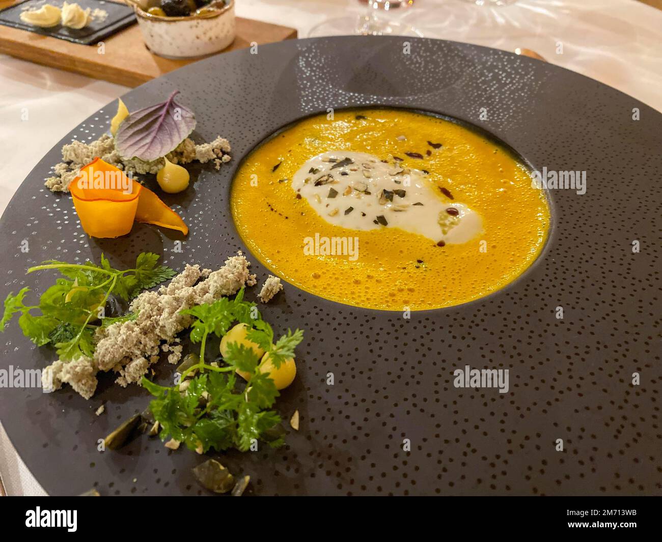 Appetizer, pumpkin cream soup with cream on a finely decorated table, Hesse, Germany Stock Photo