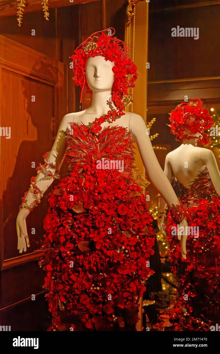 female mannequin in dress of red flowers, headpiece, unique, colorful, festive, back reflected in mirror, Stock Photo
