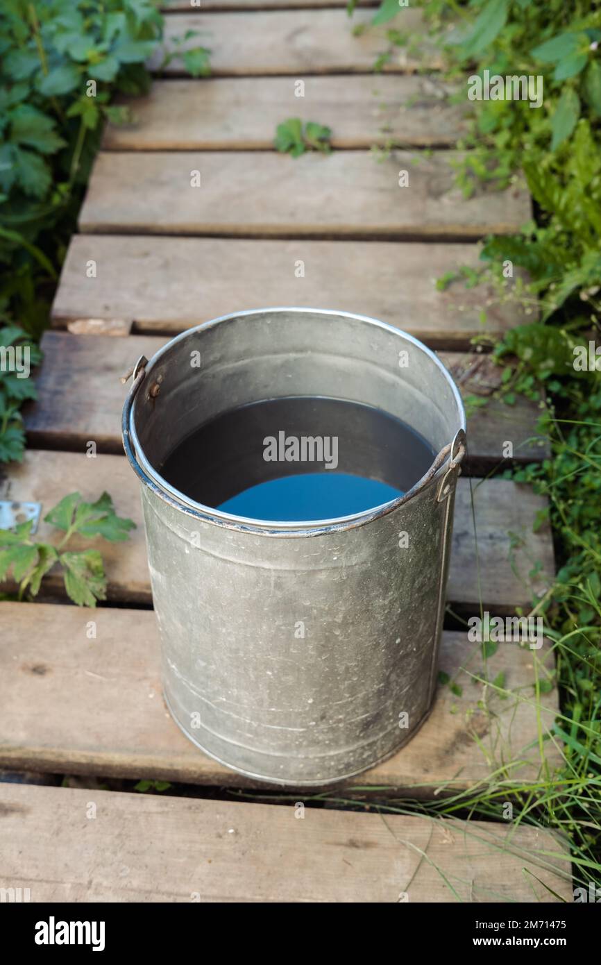 iron bucket with water in the country in the summer, top view Stock Photo -  Alamy