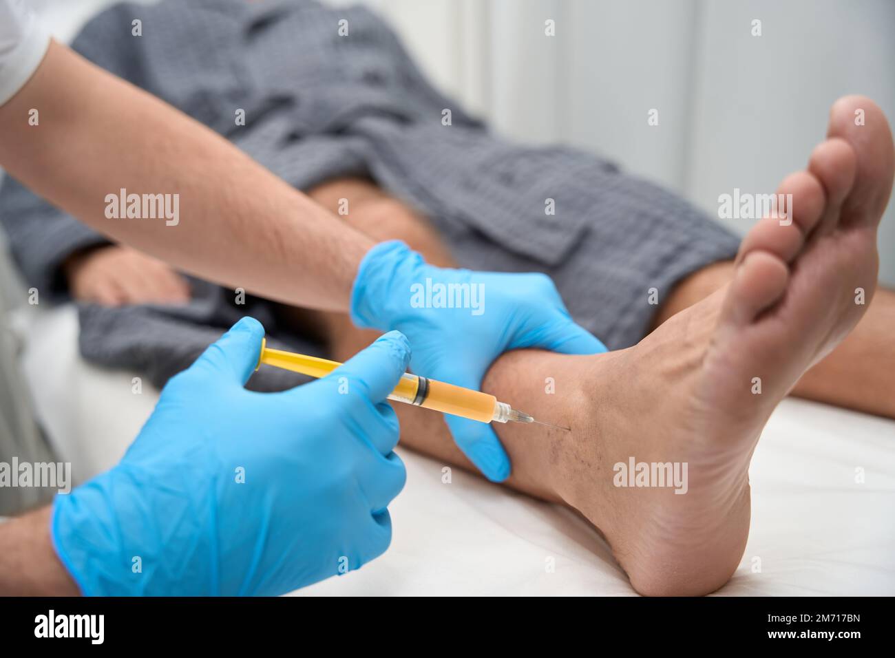 Medical specialist collecting a biopsy sample with a needle Stock Photo ...