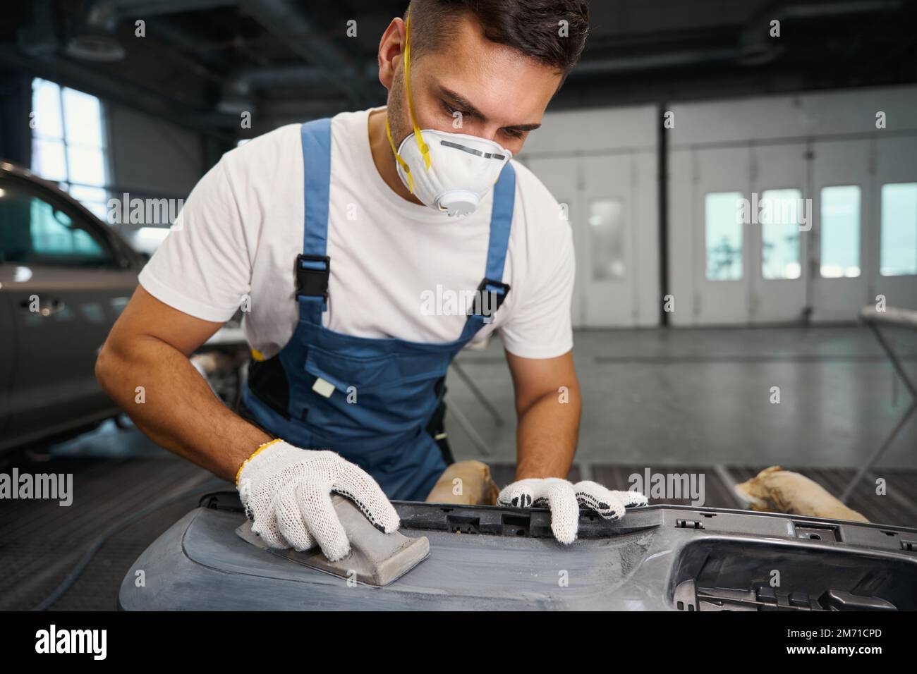 Mechanic stripping paint before painting car detail Stock Photo Alamy