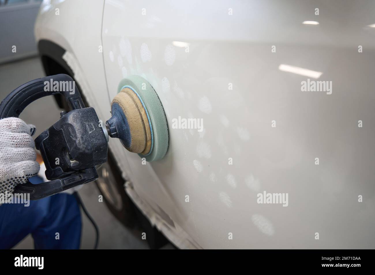 Male polishing car after painting in garage Stock Photo Alamy