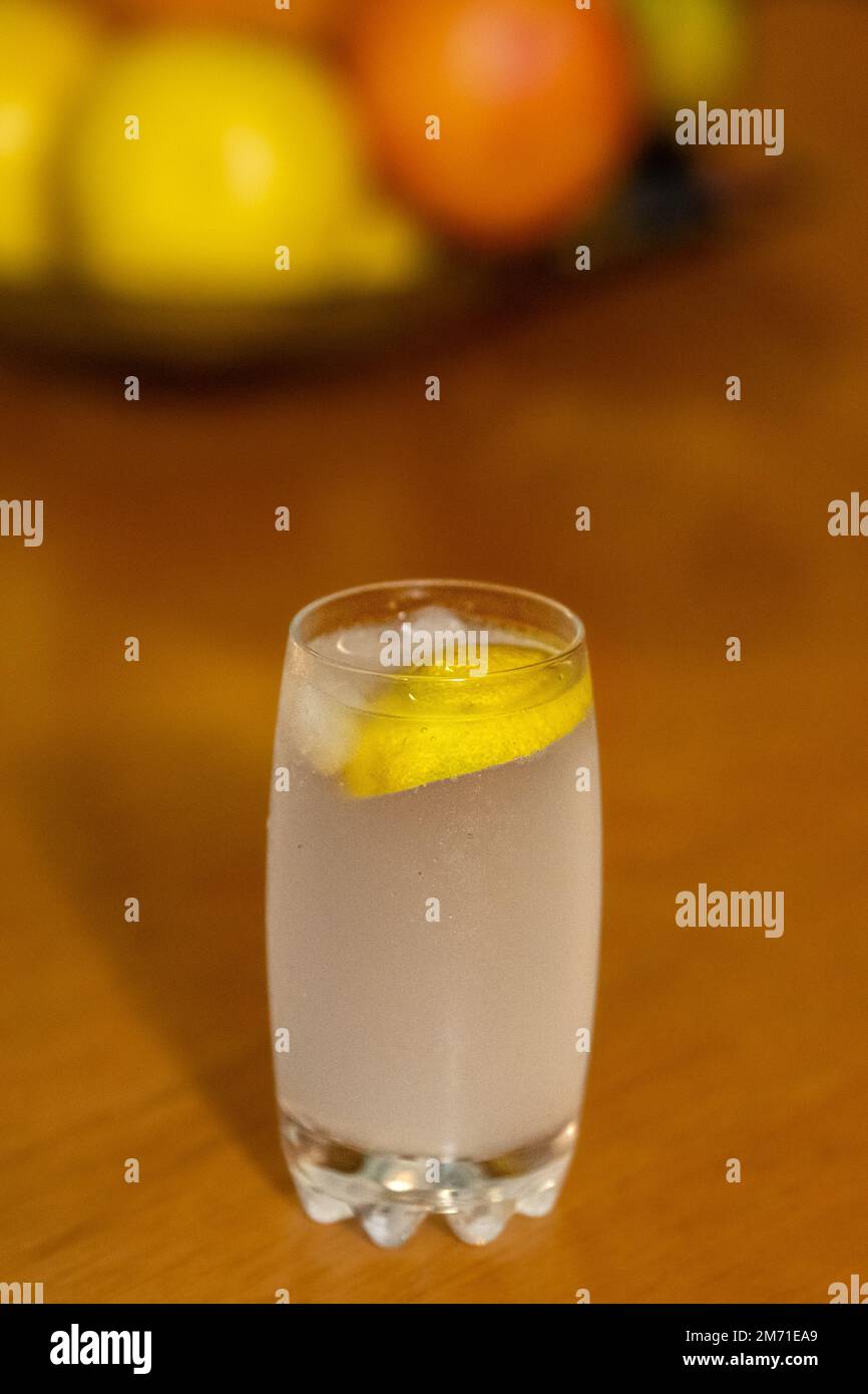 Glass cup with sparkling water and lemon. wooden background, Citrus